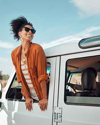 woman hanging outside of car